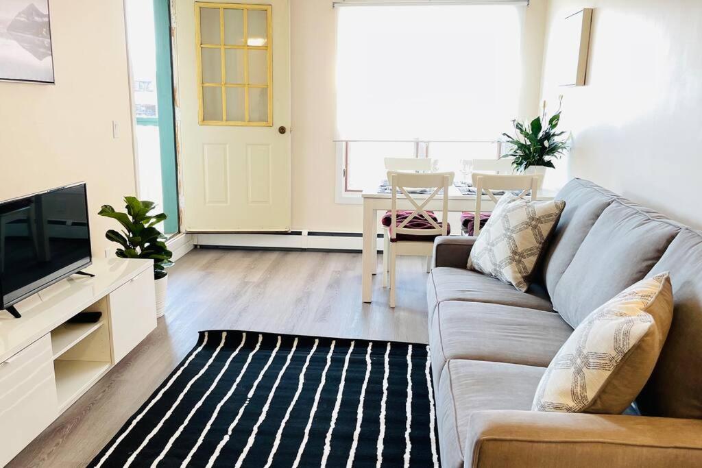 a living room with a couch and a tv and a table at unit #303 Mountain view 1BR in Canmore DownTown in Canmore