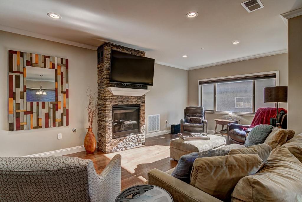 a living room with a couch and a fireplace at Tahoe Woods Hideout in South Lake Tahoe