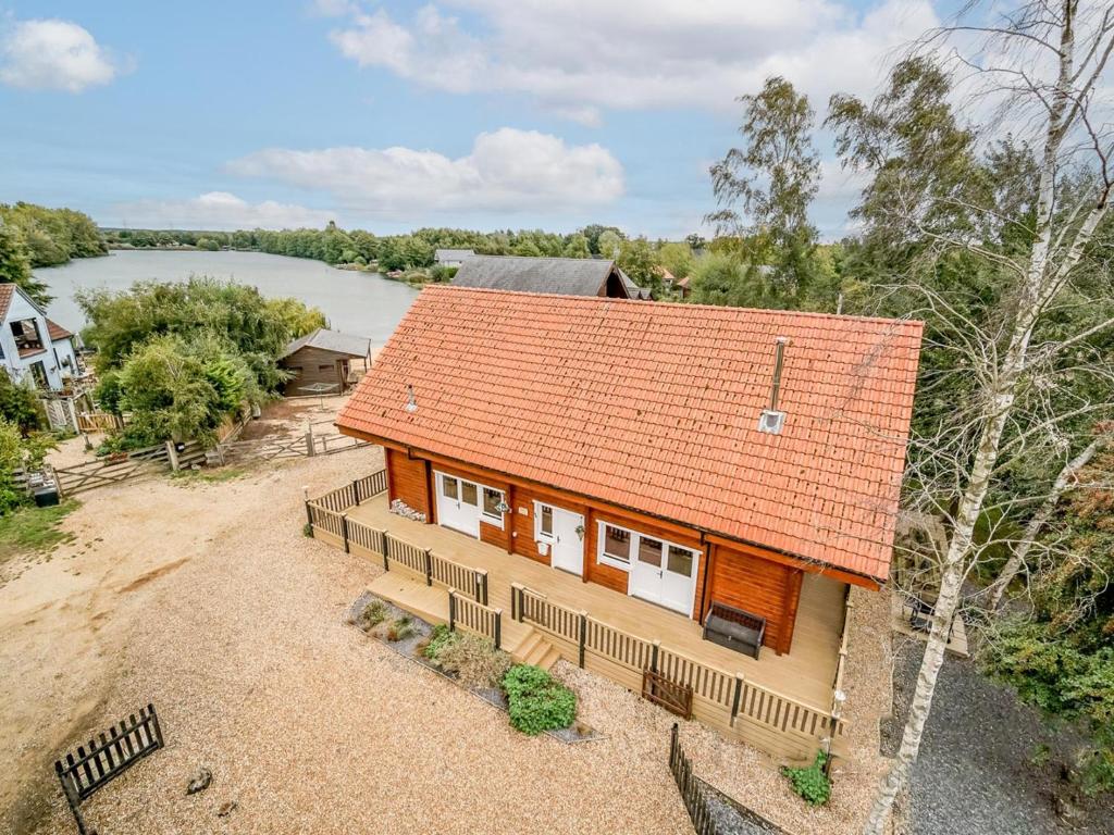 an overhead view of a house with an orange roof at Stunning Log Cabin With A Pool Table For Hire In Norfolk, Sleeps 8 Ref 34045al in Kings Lynn