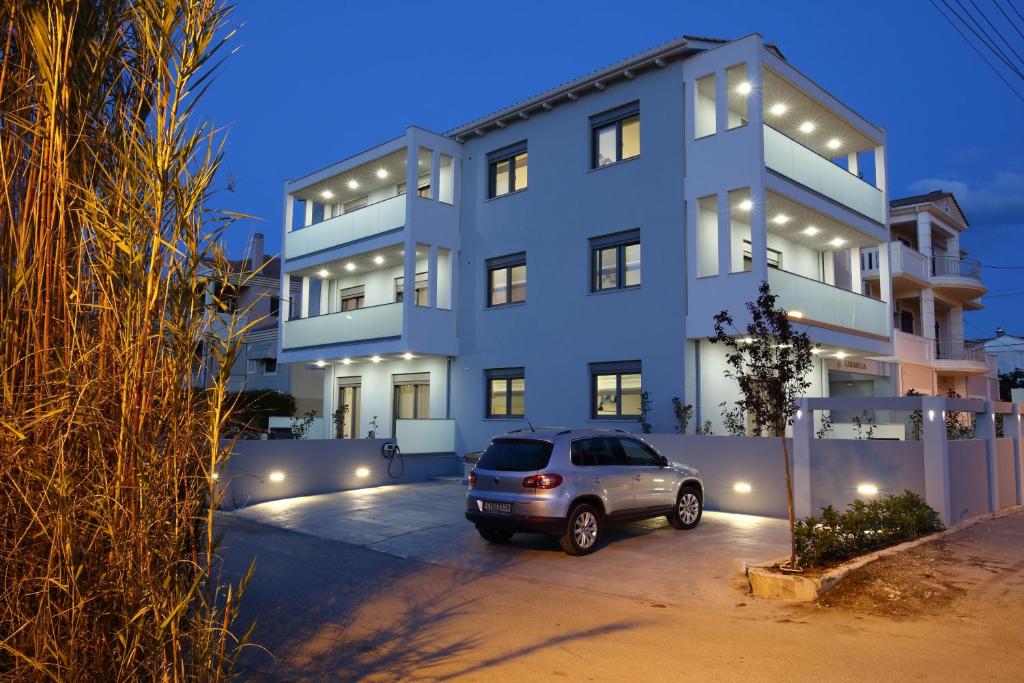 a car parked in a parking lot in front of a building at Carabella Residence in Lefkada Town