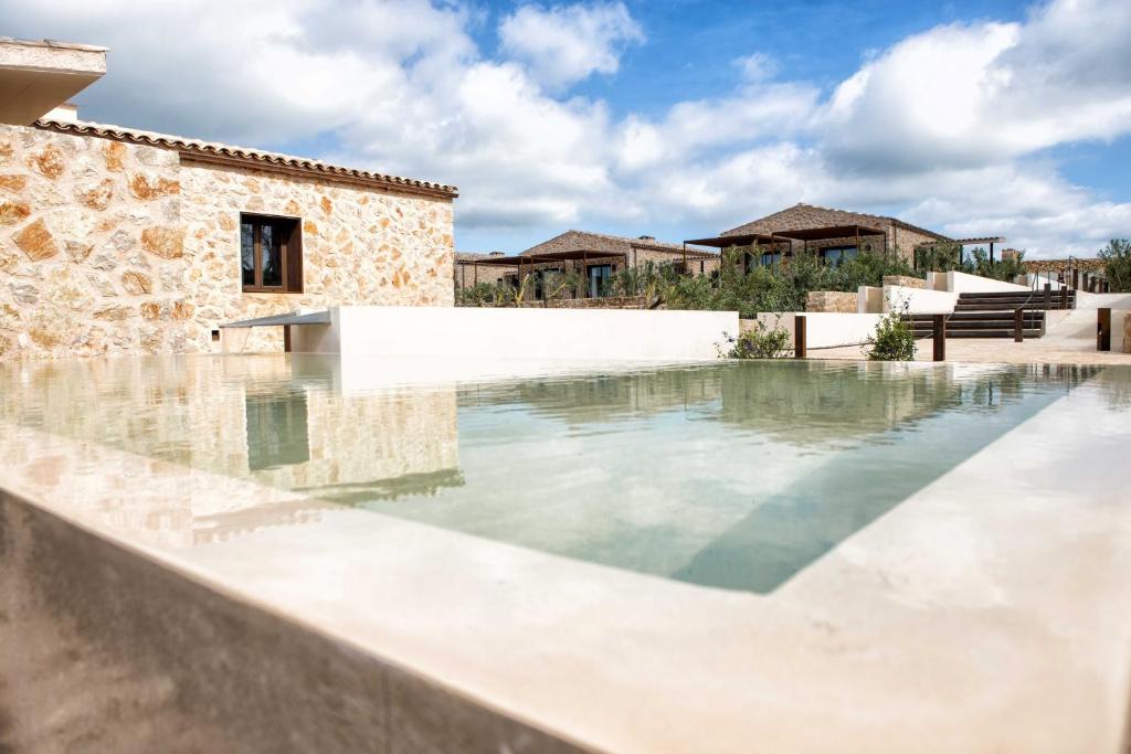 
a large swimming pool in a large building at Hotel Son Trobat Wellness & Spa in Sant Llorenç des Cardassar
