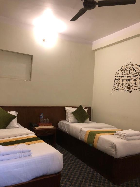 Postel nebo postele na pokoji v ubytování Bouddha Green Hotel