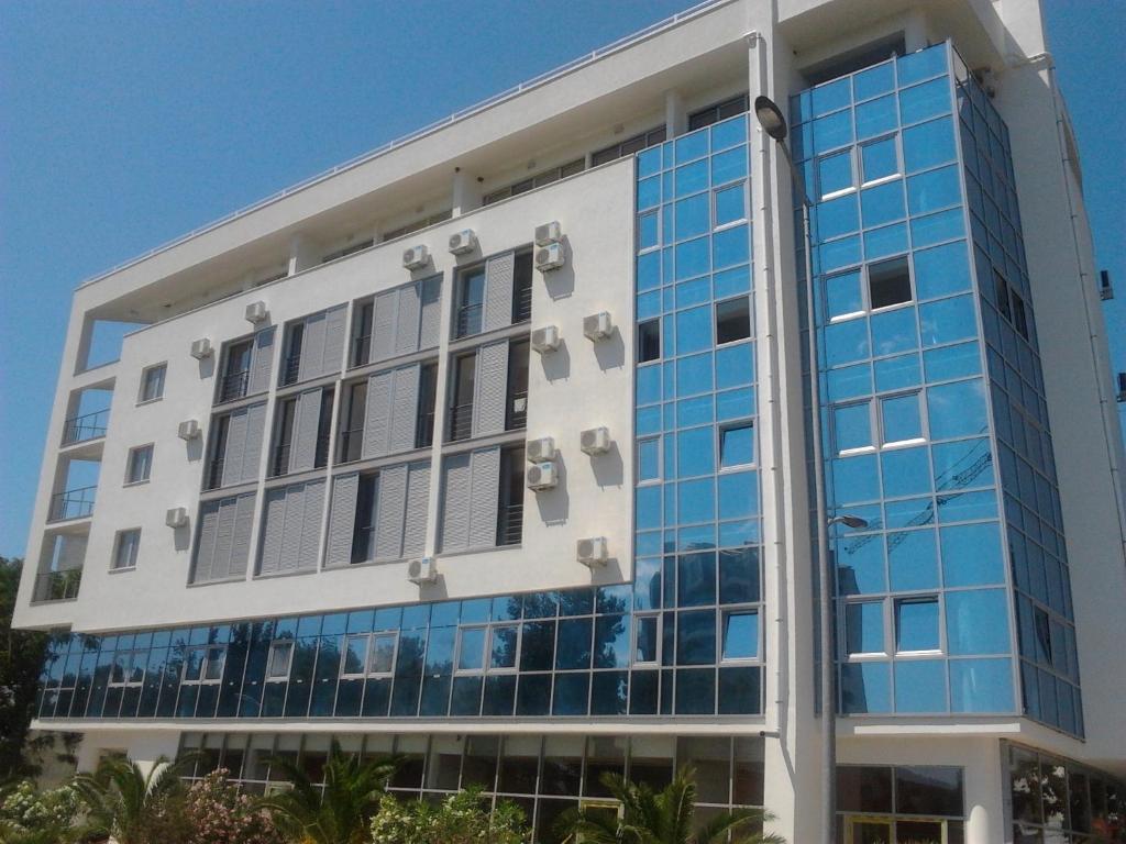 an office building with blue glass windows at Apartment Marina in Bar