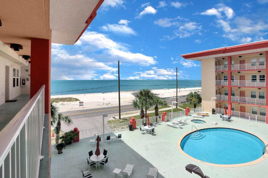 a view from a balcony of a hotel with a pool and the beach at Paradise Shores 310 by Pristine Properties Vacation Rentals in Mexico Beach