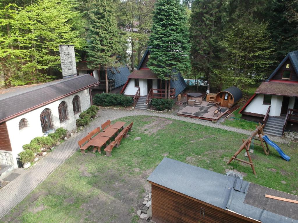 an aerial view of a park with a bench and a building at Domki Brenna Leśnica in Brenna