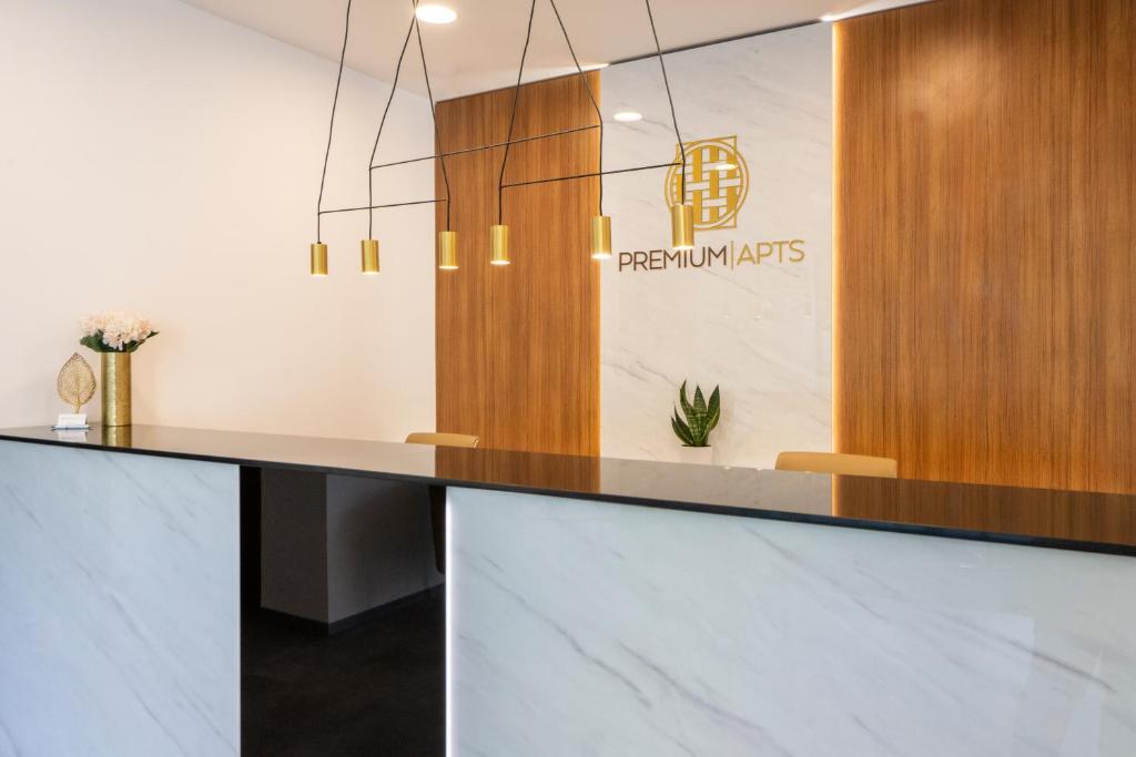 a reception desk in a office with a potted plant at Premium Apartments in Budapest