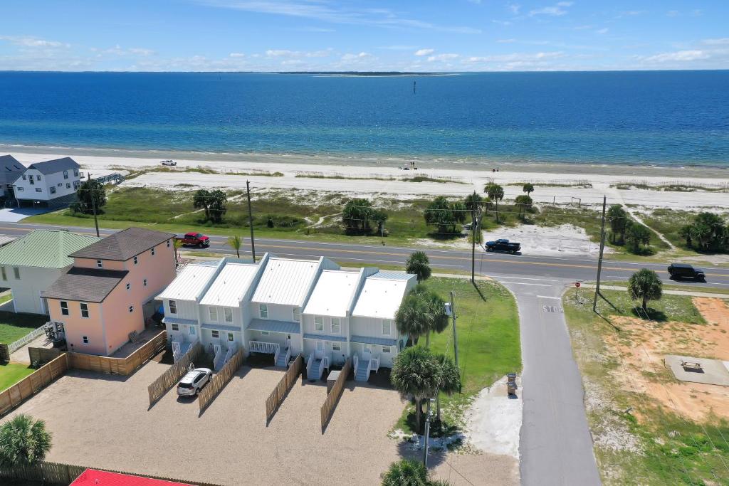 an aerial view of a building next to the beach at Stay Salty in Saint Joe Beach
