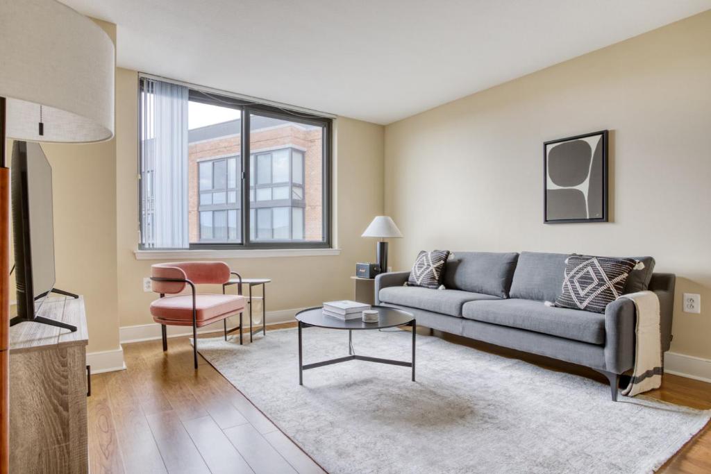 a living room with a couch and a table at Mount Vernon 2BR w WD Gym nr Chinatown WDC-565 in Washington