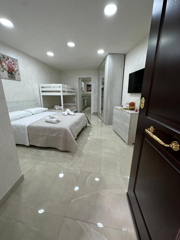 um quarto com uma cama e uma televisão em ChloeHouse em Nápoles