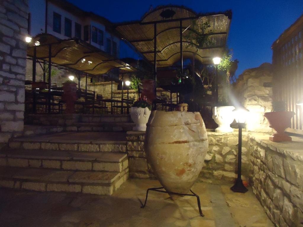 a large stone vase sitting in front of a building at Hotel Klea in Berat
