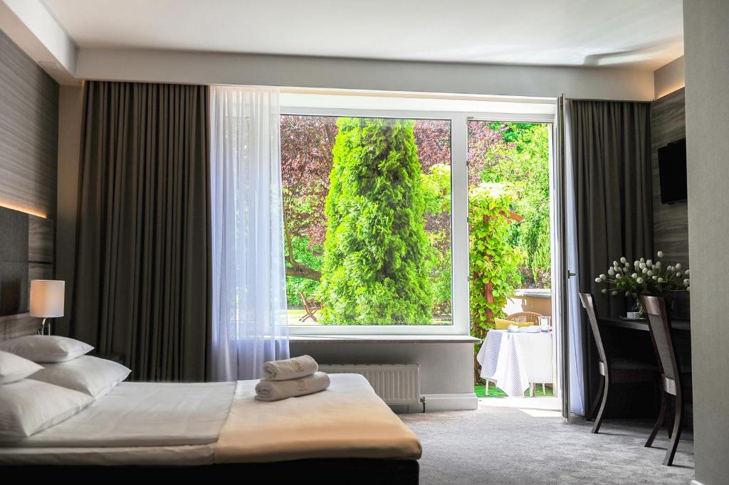 Postel nebo postele na pokoji v ubytování Hotel Villa Eva