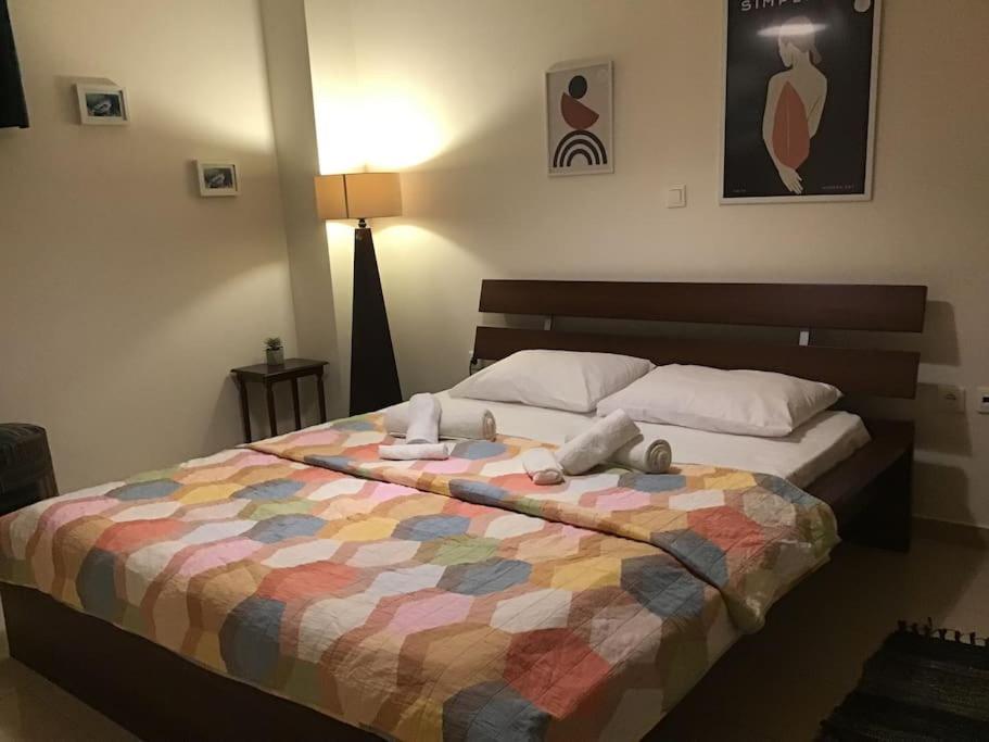 a bedroom with a bed with a colorful quilt at Appartment in Nea Erithrea in Athens