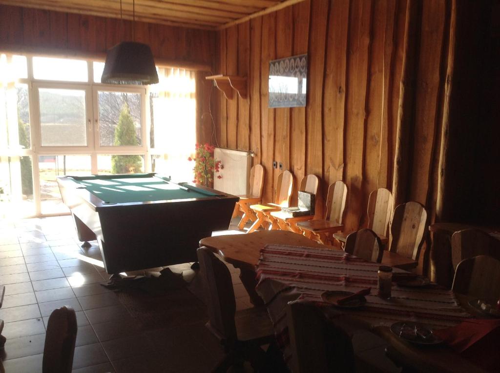 a living room with a pool table and chairs at Club Torony Hotel in Torony