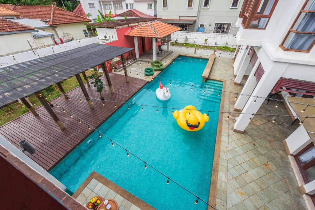 an overhead view of a swimming pool with an inflatable at Tropical Bliss Luxe 5BR 30Pax Private Pool Villa KL by Verano in Kuala Lumpur