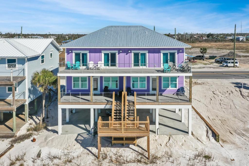 a purple house sitting on top of a beach at Beach Fantasies A by Pristine Properties Vacation Rentals in Mexico Beach
