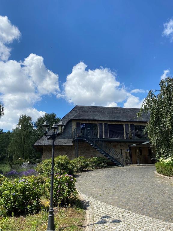 a house with a deck and a staircase on it at Hof Arche in Neuenkirchen-Vörden