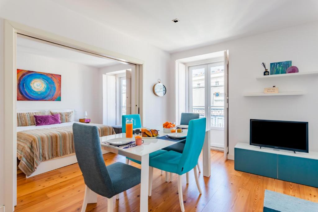 a living room with a dining room table and a bedroom at Lisbon Prime Apartment in Lisbon