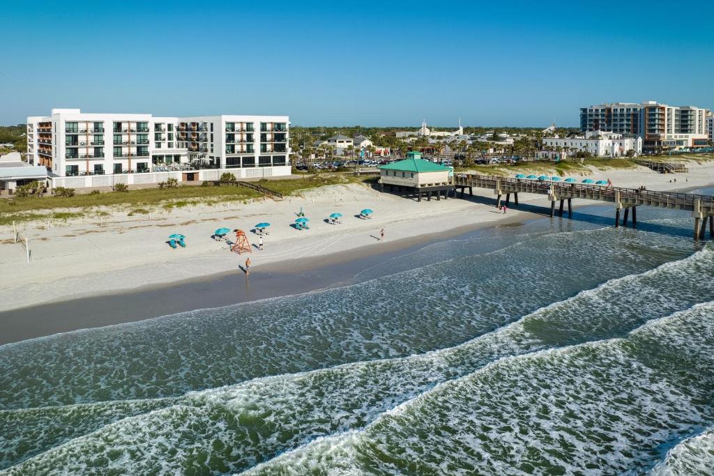 an aerial view of a beach with a pier at SpringHill Suites by Marriott Jacksonville Beach Oceanfront in Jacksonville Beach