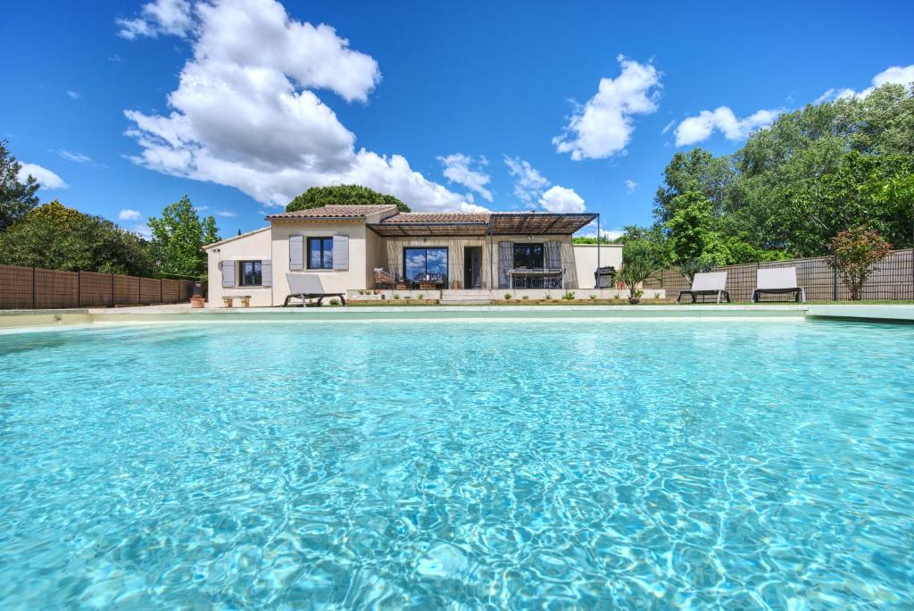 a house with a pool of water in front of it at Mazet Brunelly in Paradou