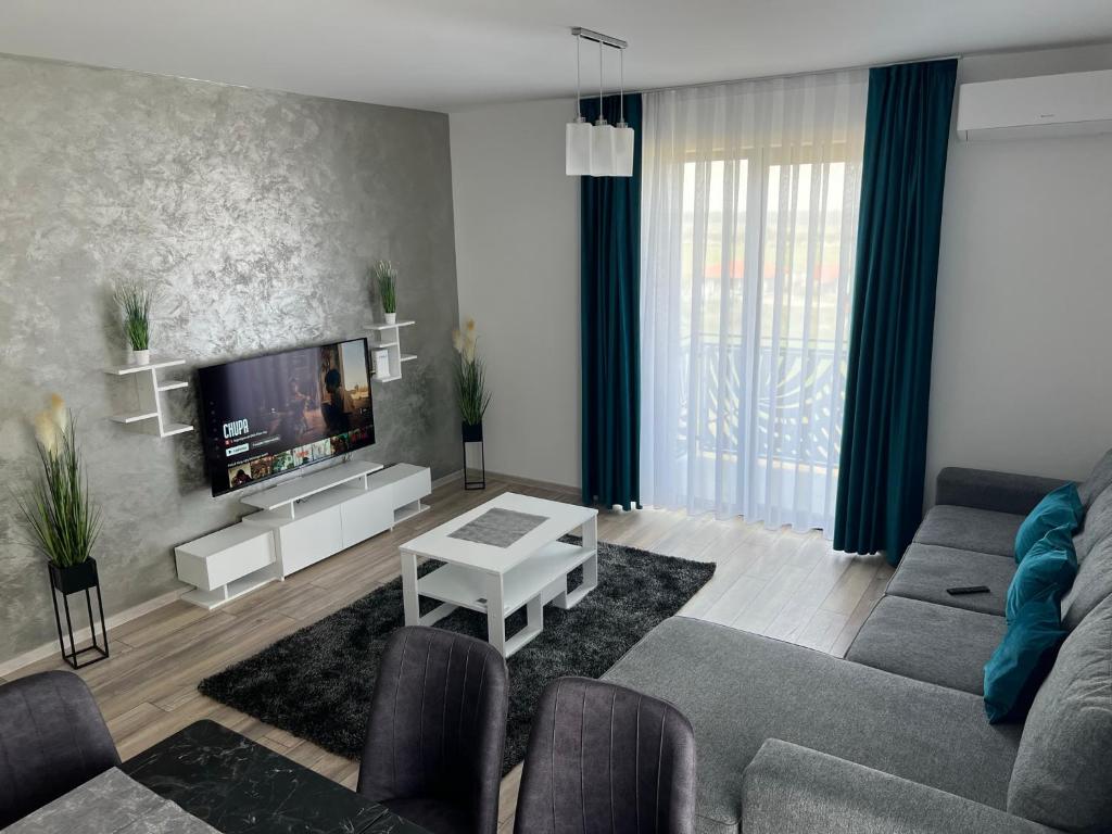 un salon avec un canapé et une télévision dans l'établissement Gala Residence Baile Felix, à Cordău
