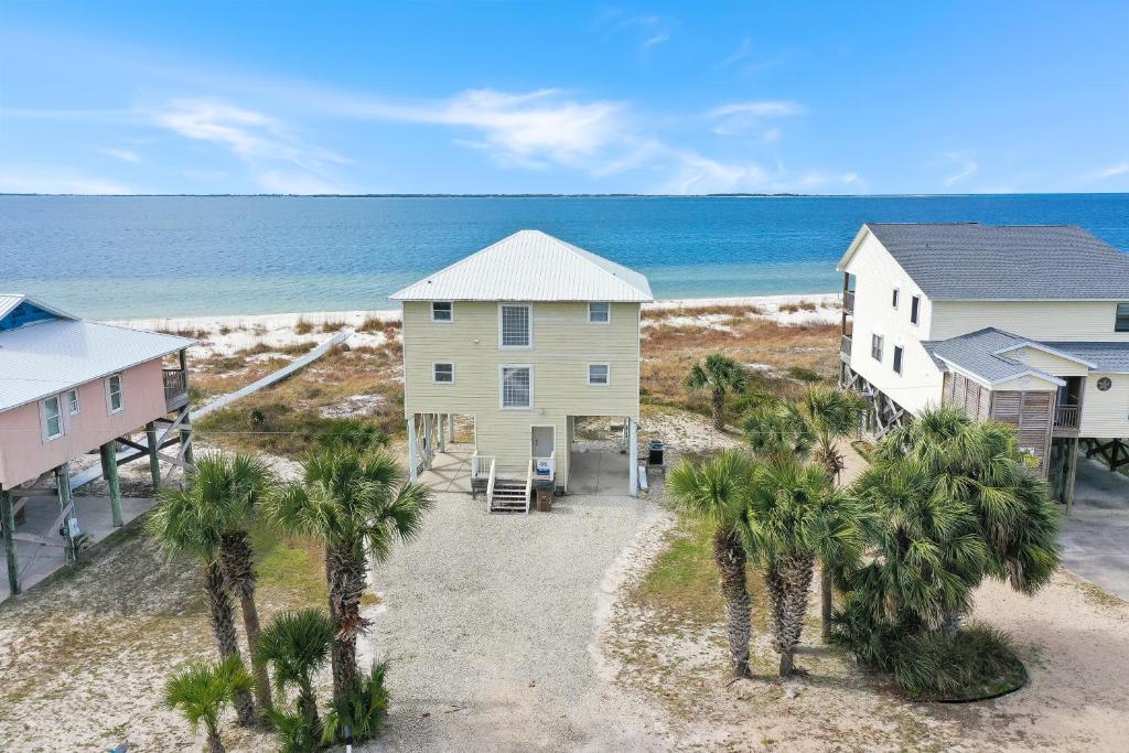 a house on the beach with palm trees at Flamingo Dunes by Pristine Properties Vacation Rentals in Saint Joe Beach