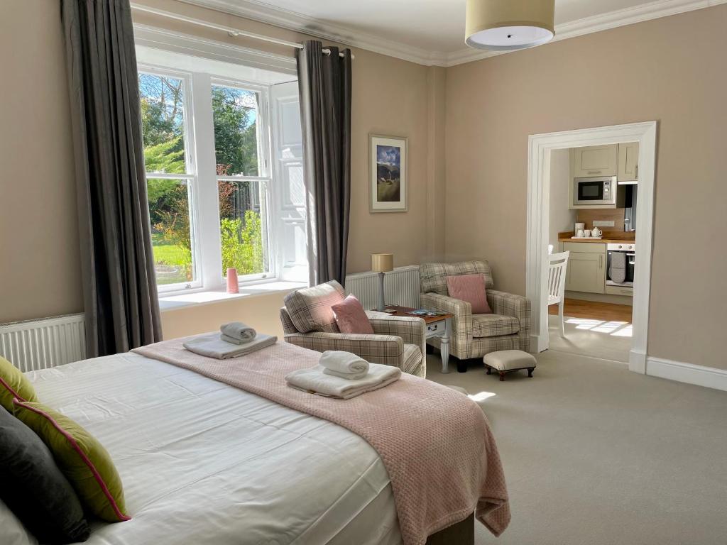 a bedroom with a bed and a living room at Bethby Beck Apartment Keswick in Keswick