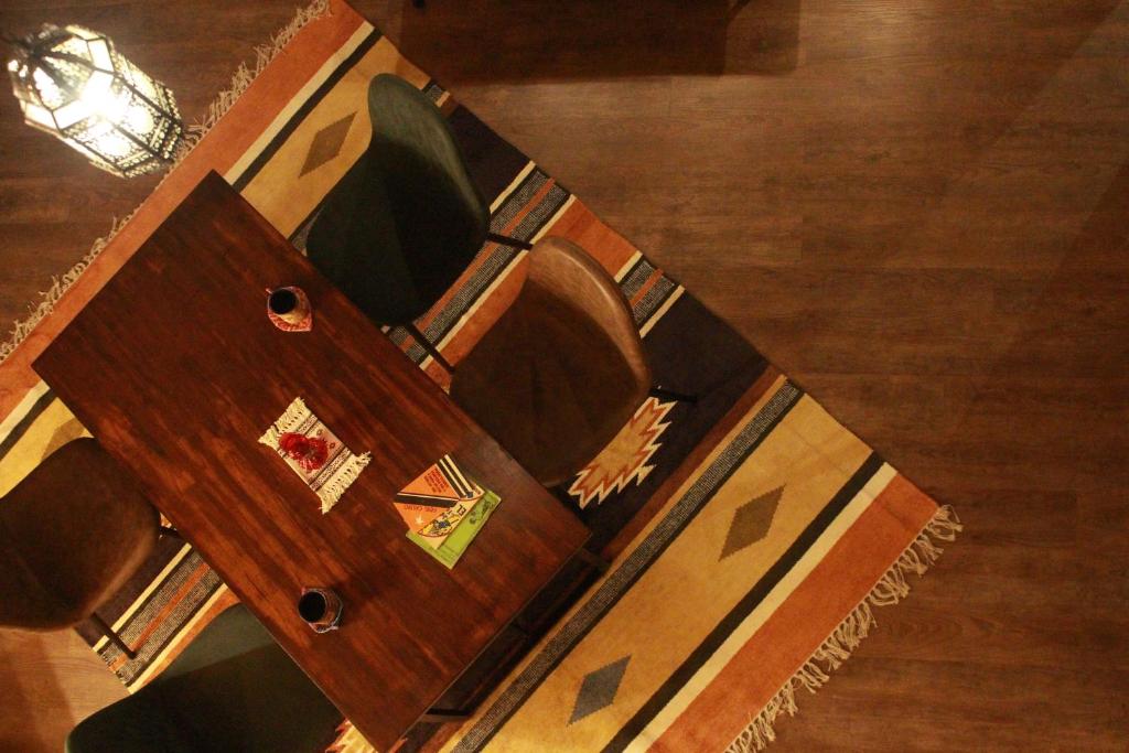 a wooden table with a wooden box on the floor at 星空に包まれる 森の隠れ家　Amrita Lodge ~stay & retreat~ in Kirishima