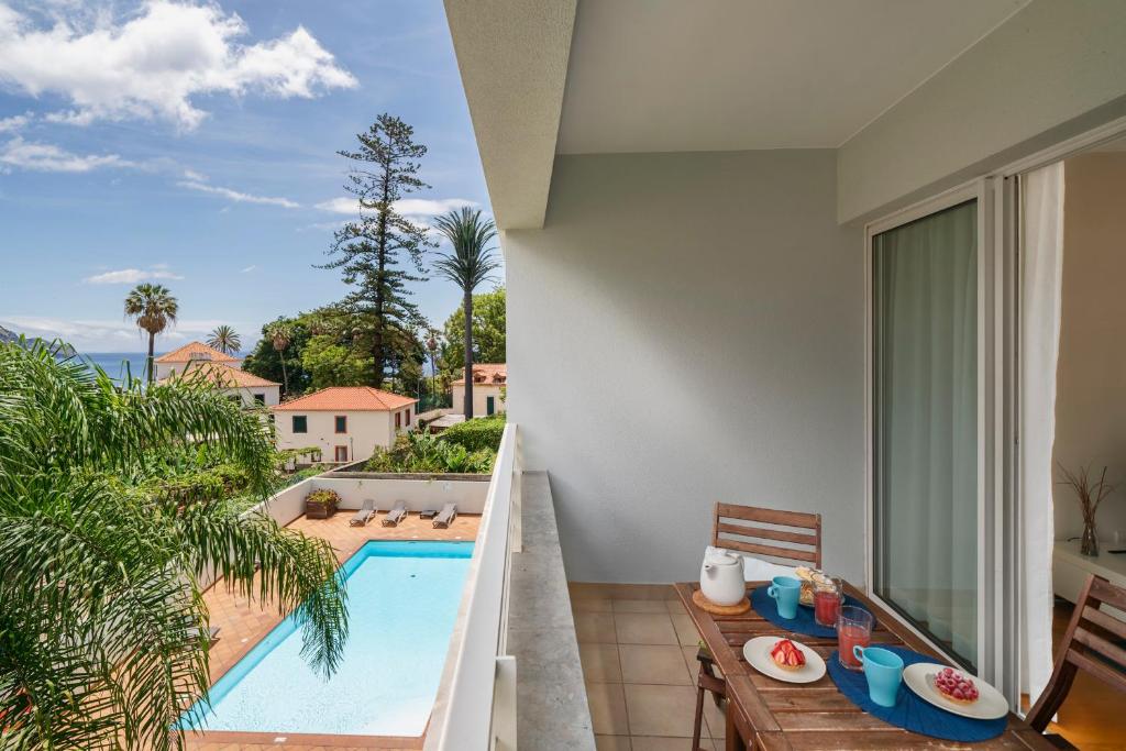 a balcony with a view of a swimming pool at Jasmineiro II by An Island Apart in Funchal