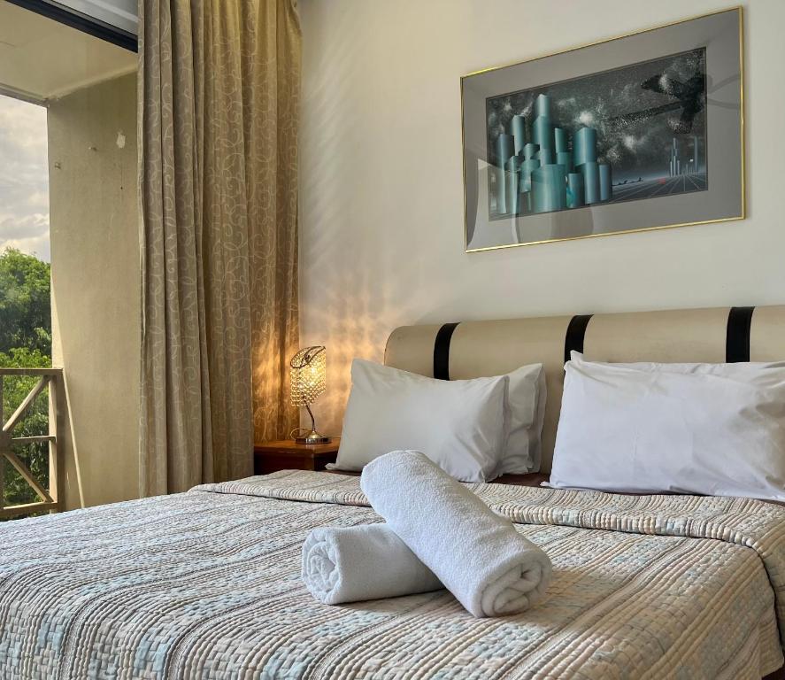 a hotel room with a bed with towels on it at Country Side Modern Concept Cottage in Bentong