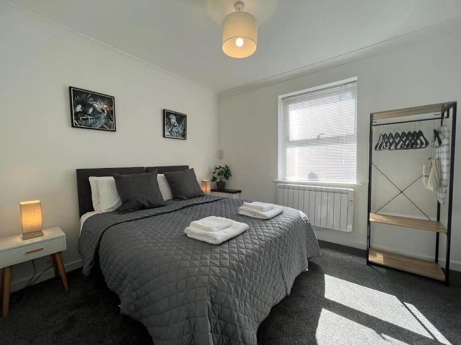 a bedroom with a bed with two towels on it at Flat 2 High Street Apartments, One Bed in Wellington