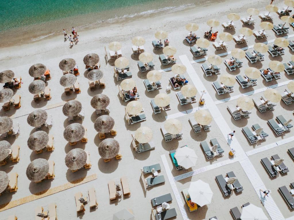 an overhead view of a beach with tables and umbrellas at Beach Deluxe House in Kos Town