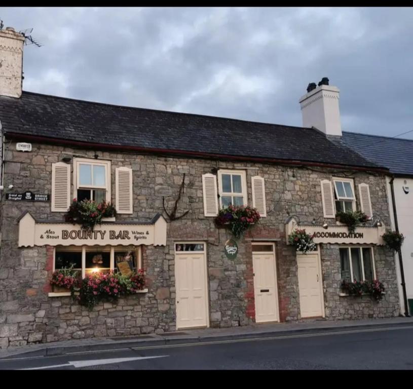 a stone building with flowers on the front of it at Bounty Bar in Trim