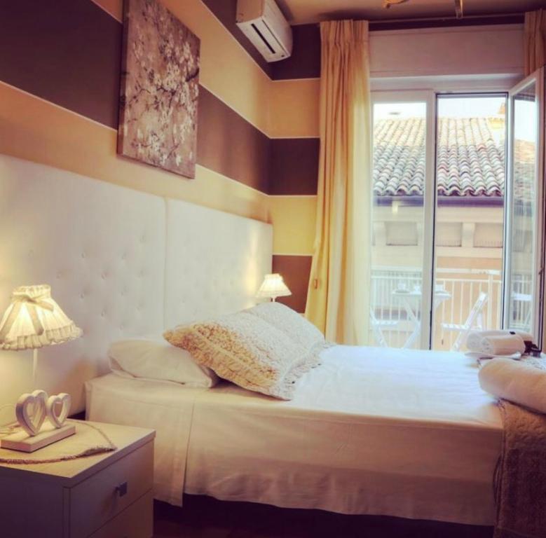 a bedroom with a bed and a window at La Casetta di Lina Rooms and Apartments in Verona