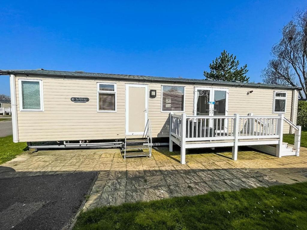 a mobile home with a porch and a deck at Brilliant 8 Berth Caravan With Decking At Haven Caister Beach Ref 30055p in Great Yarmouth