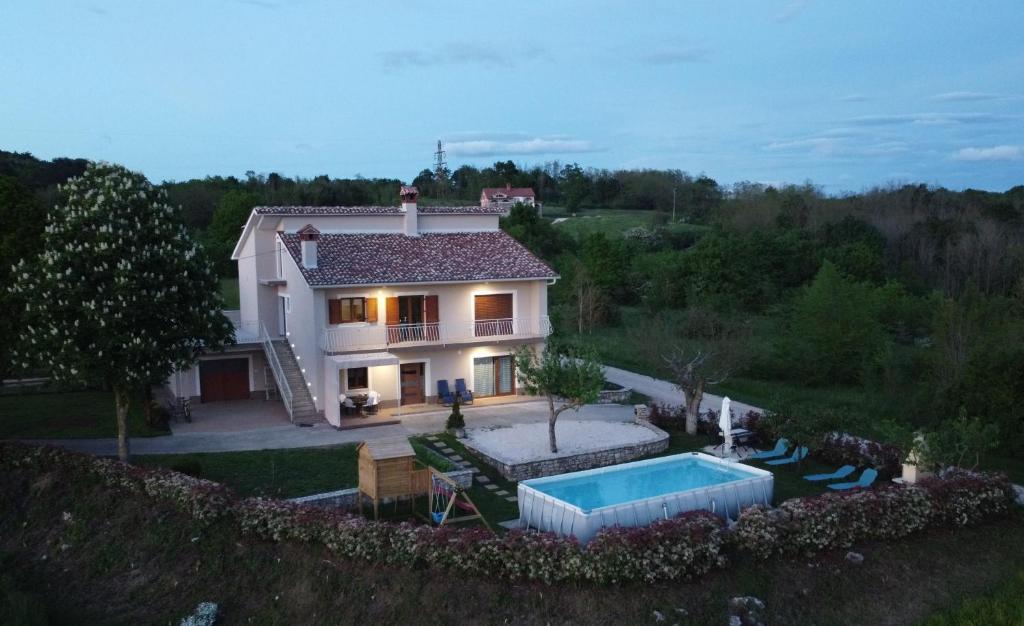 a house with a swimming pool in the yard at Holiday home Nona in Motovun