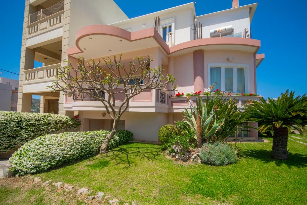 a pink house with a garden in front of it at Jasmine House Kissamos in Kissamos