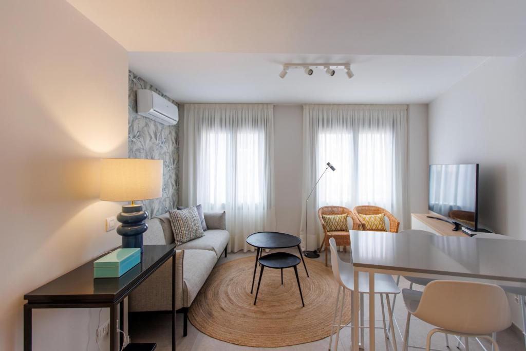 a living room with a couch and a table at NEW Stylish 2 Bedroom Apt in Las Palmas de Gran Canaria