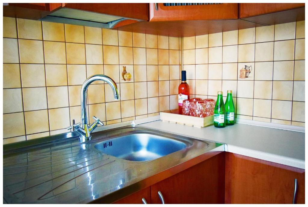 a kitchen counter with a sink in a kitchen at Color24 Apartament VI in Stalowa Wola