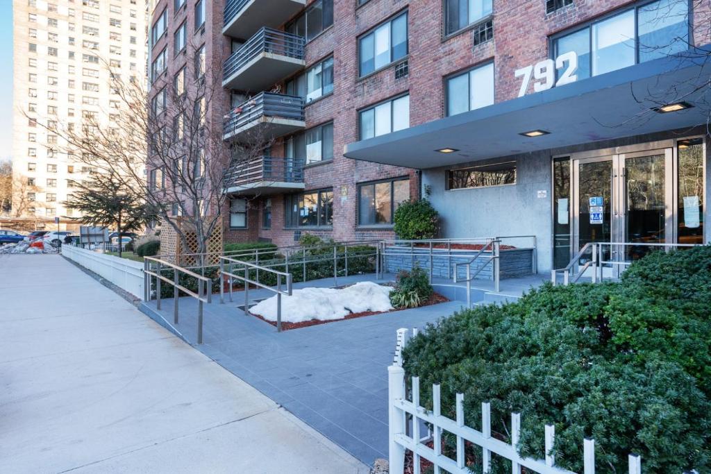 a building with a fence in front of it at Gorgeous 2 BR in NYC with Elevator in New York