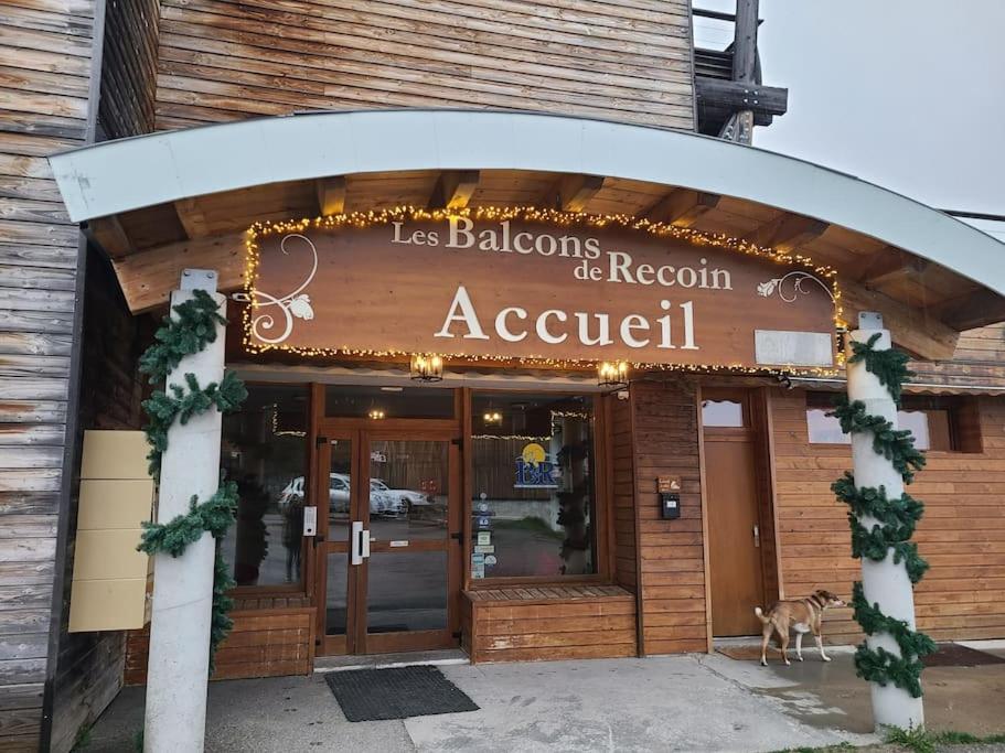 a restaurant with a sign on the front of it at Grand appartement au pied des pistes ! in Chamrousse