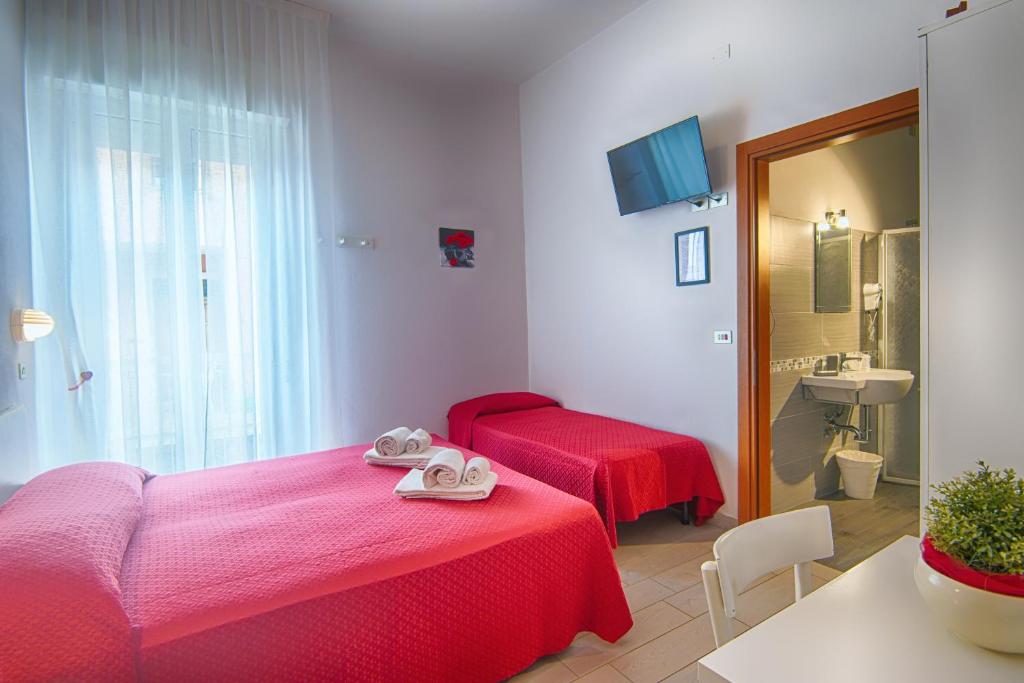 Postel nebo postele na pokoji v ubytování Hotel Raimondi