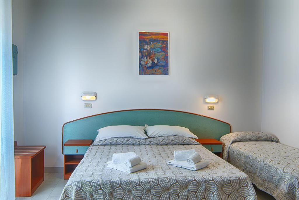 Postel nebo postele na pokoji v ubytování Hotel Raimondi