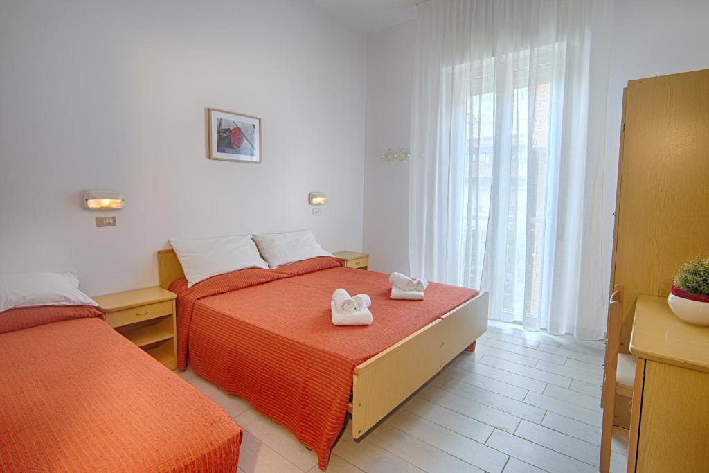 Postel nebo postele na pokoji v ubytování Hotel Raimondi