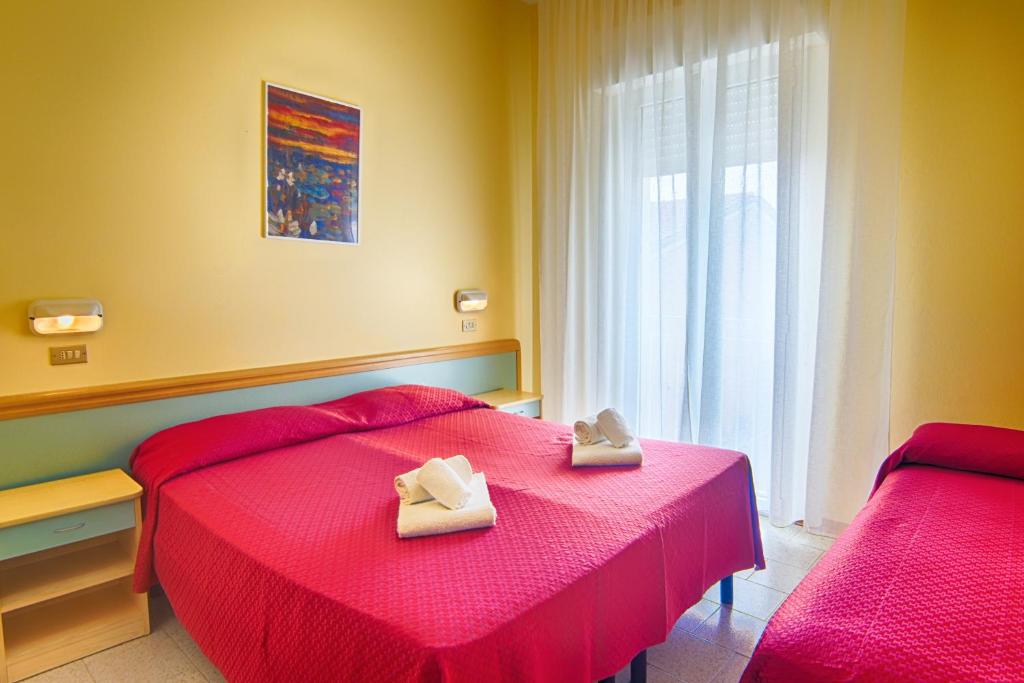 Postel nebo postele na pokoji v ubytování Hotel Raimondi