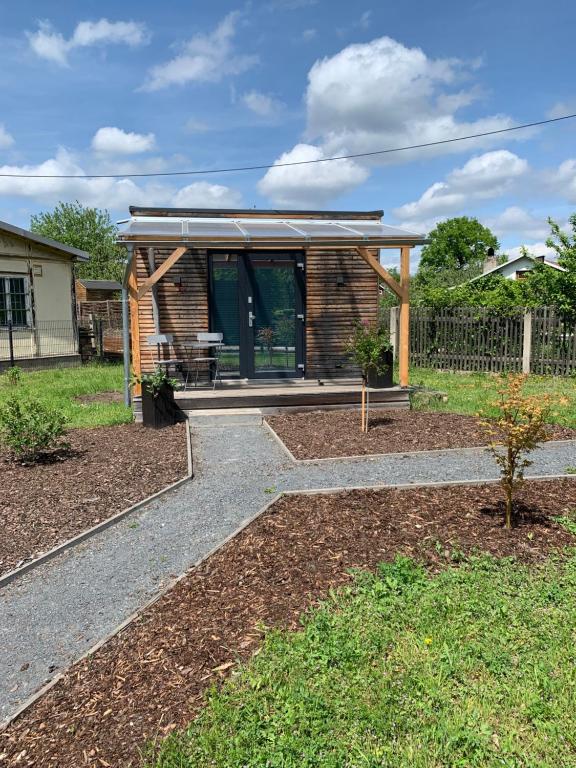 a small house with a patio and a fence at Tiny House Lodge Dresden in Dresden
