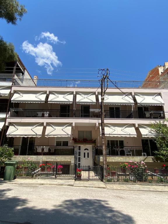 a large building with white umbrellas in front of it at Villa Vasiliki in Metamorfosi