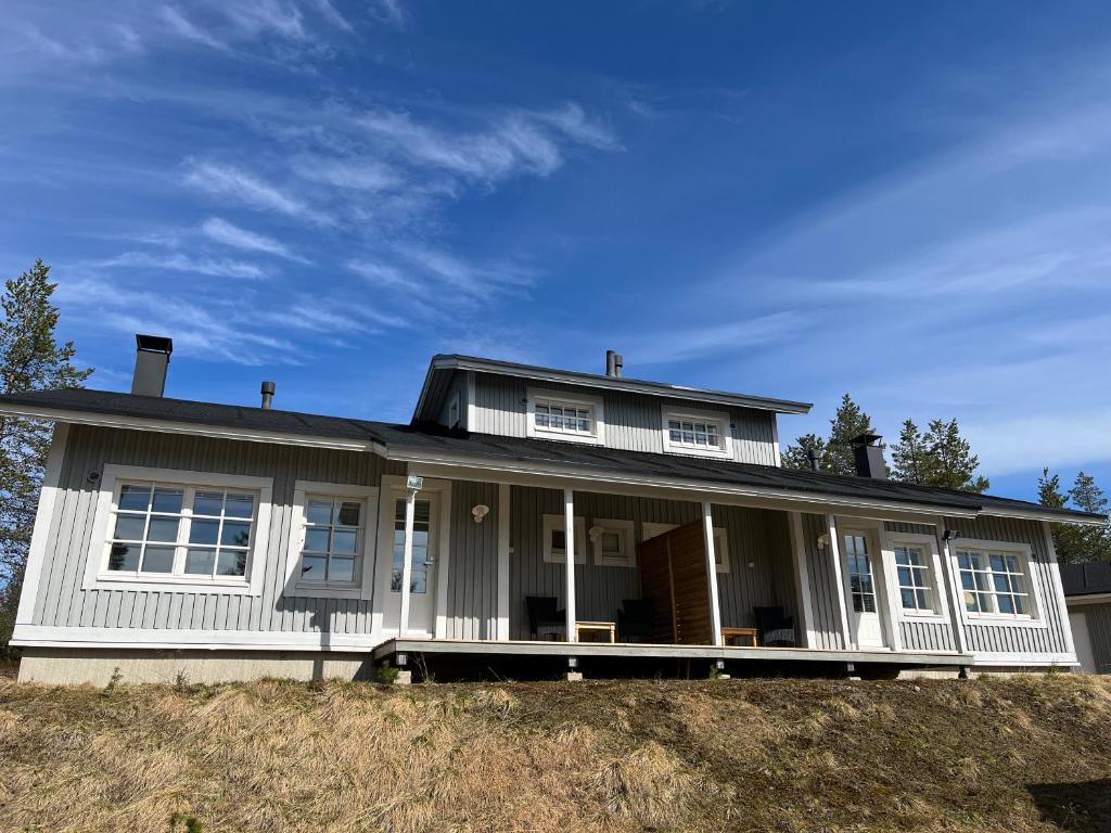 a white house on top of a hill at Castillo Vuorsa 3 in Saariselka