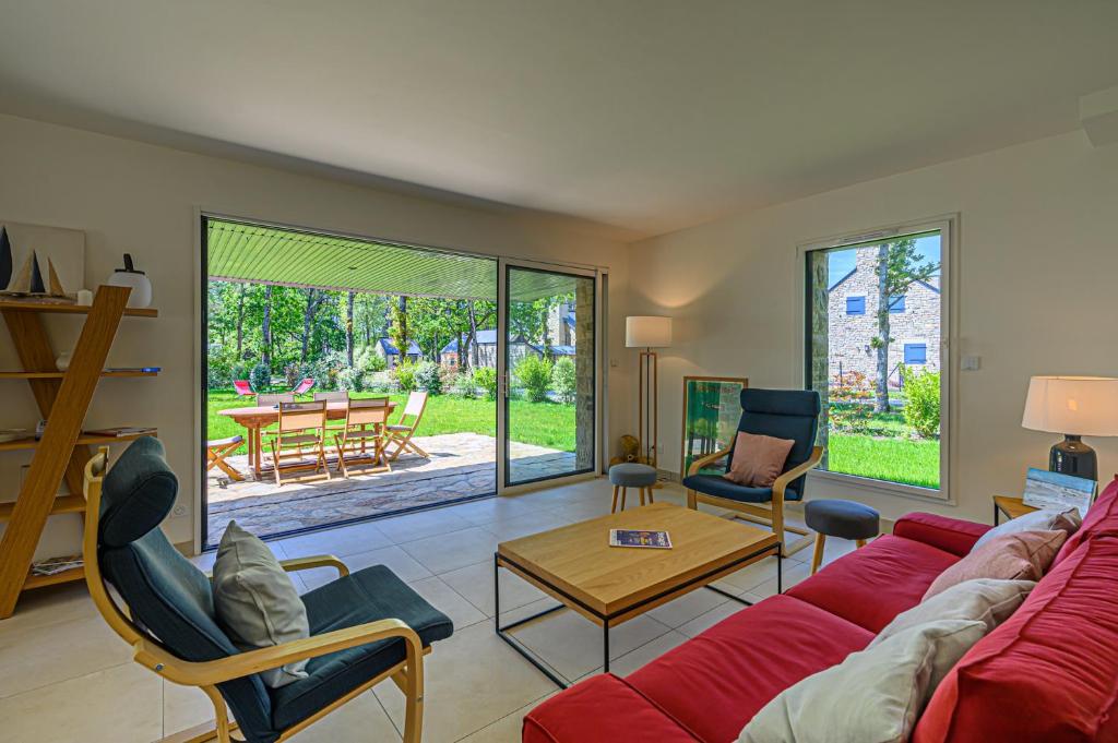 a living room with a red couch and chairs at Les Dryades - Villa familiale proche plage in Sarzeau