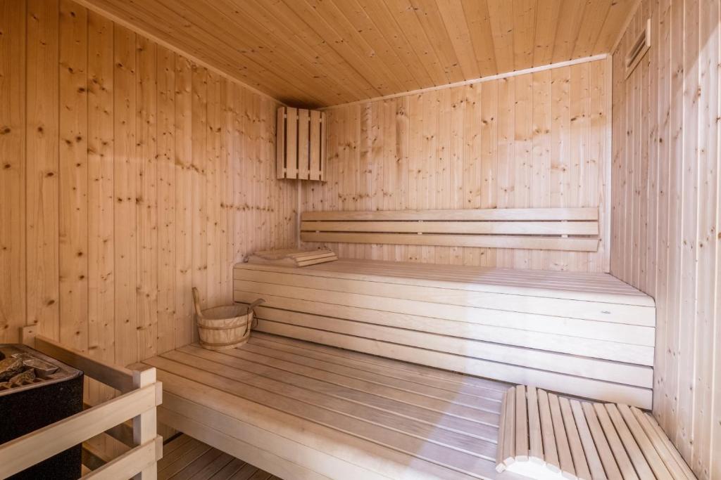 a wooden sauna with two benches in a wooden floor at Mar da Luz Resort in Luz
