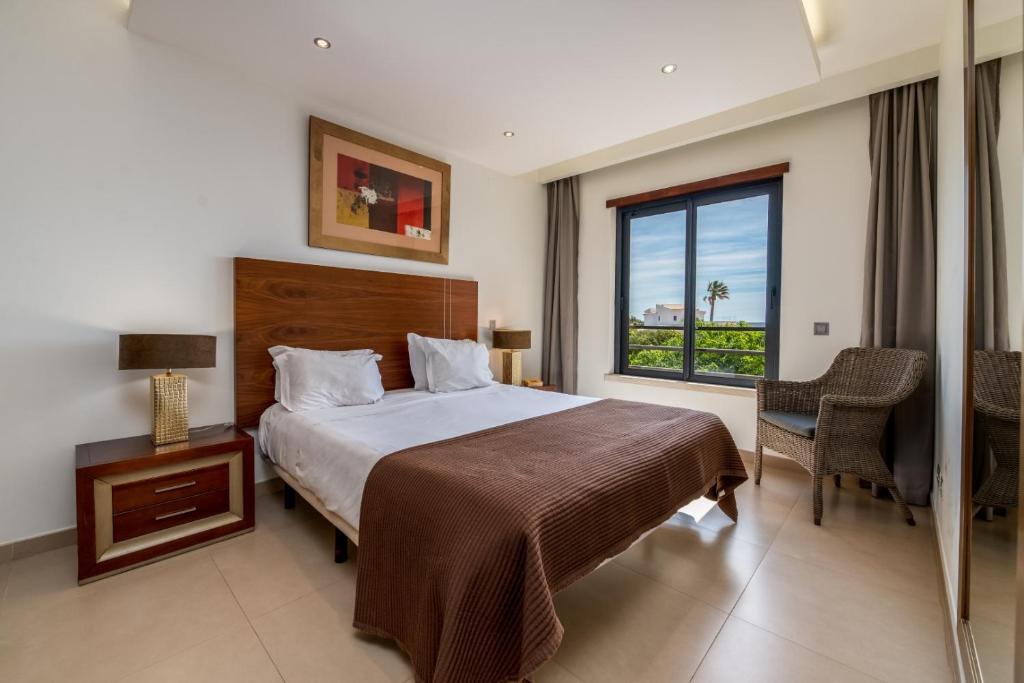 a hotel room with a bed and a window at Mar da Luz Resort in Luz